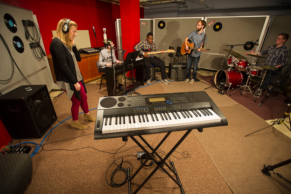 Bradley University students in the studio recording a song. 