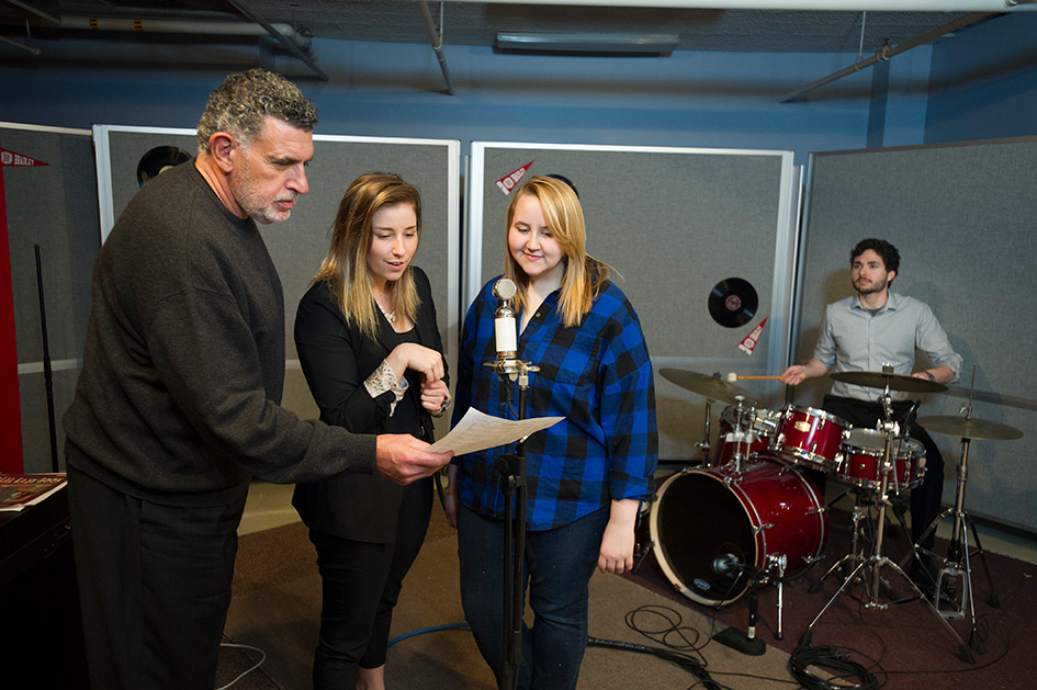 A Bradley University professor works with two students in Hilltop Studios. 