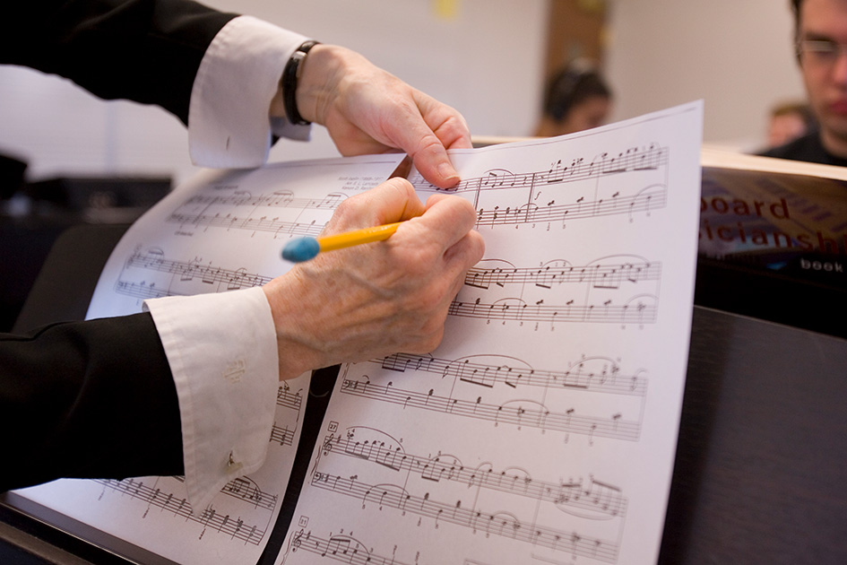 Bradley University professor helps a music student. 