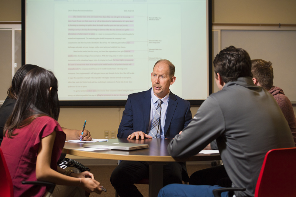 Bradley University professor talking with students. 